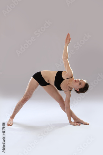 Caucasian woman is practicing yoga .