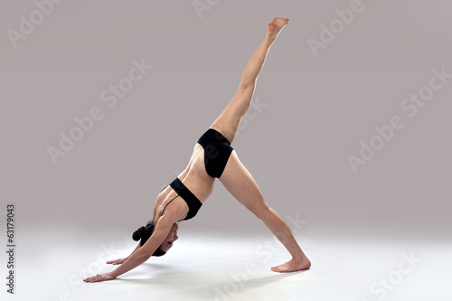 Caucasian woman is practicing yoga . © novoselov