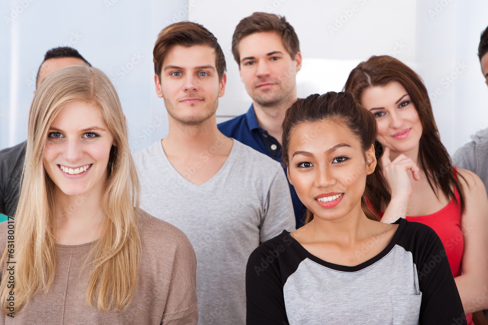 Fototapeta premium Portrait Of College Students Standing In Classroom