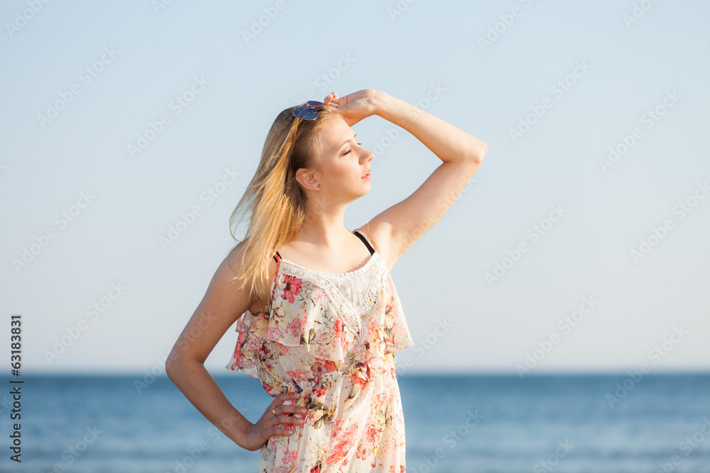 Summer vacation. Girl standing alone on the beach.