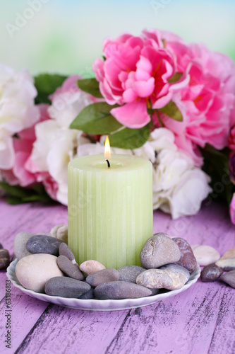 Composition with spa stones, candle and flowers