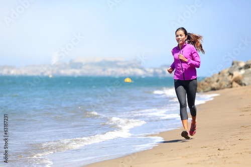 Woman running on San Francisco beach