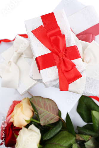 Beautiful gifts with red ribbons and flowers, close up