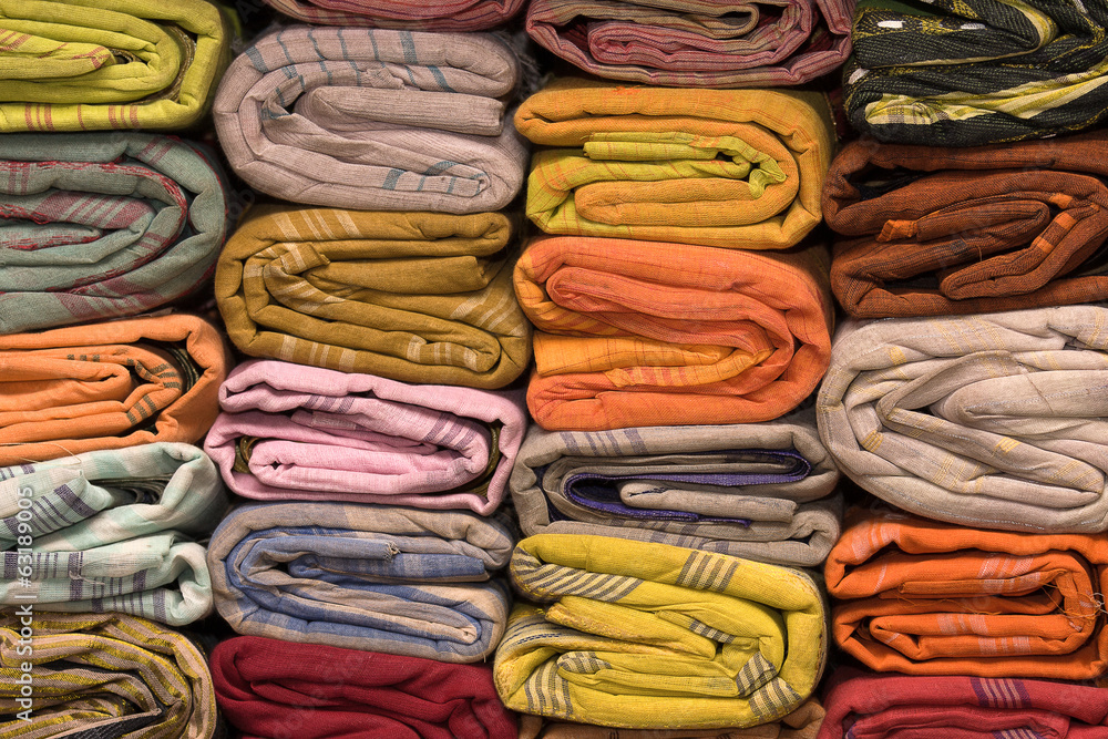 Heap of cloth fabrics at a local market in India. Close up . Heap of cloth fabrics at a local market in India. Close up .