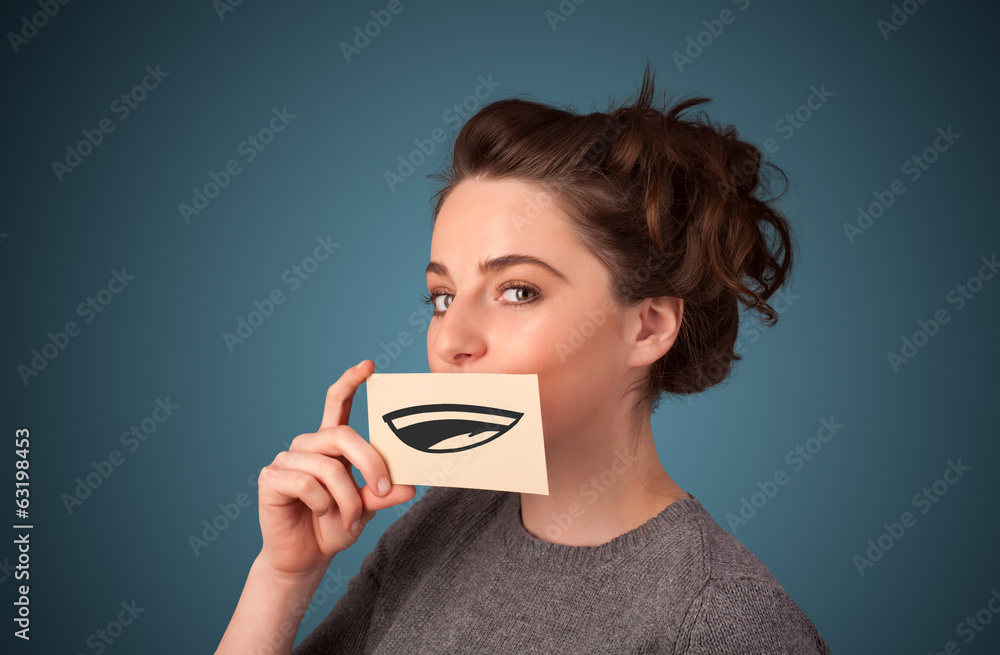 Pretty young girl holding white card with smile drawing Pretty young girl holding white card with smile drawing