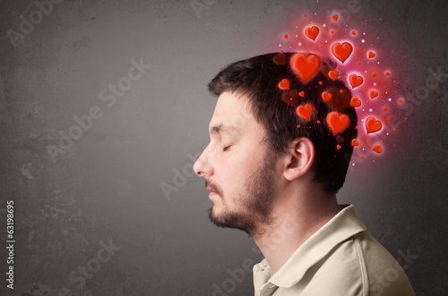 Fototapeta Naklejka Na Ścianę i Meble -  Young person thinking about love with red hearts