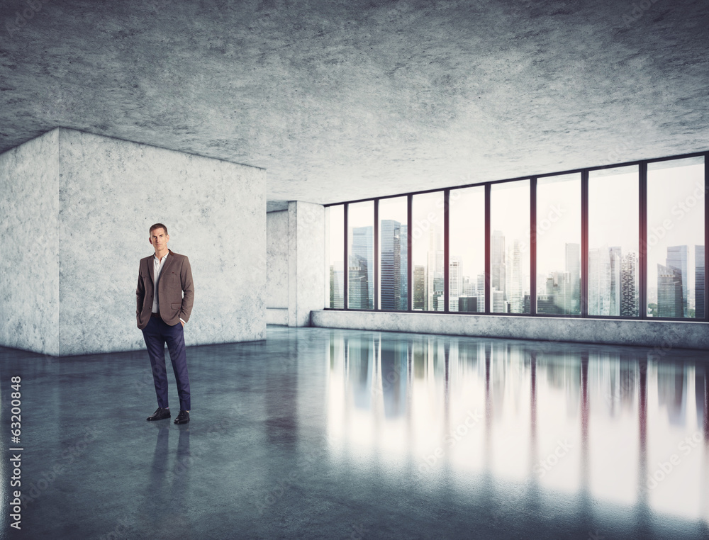 Fototapeta premium Businessman standing in modern bright office
