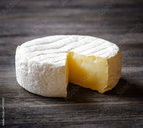 Camembert cheese on a wooden board photo