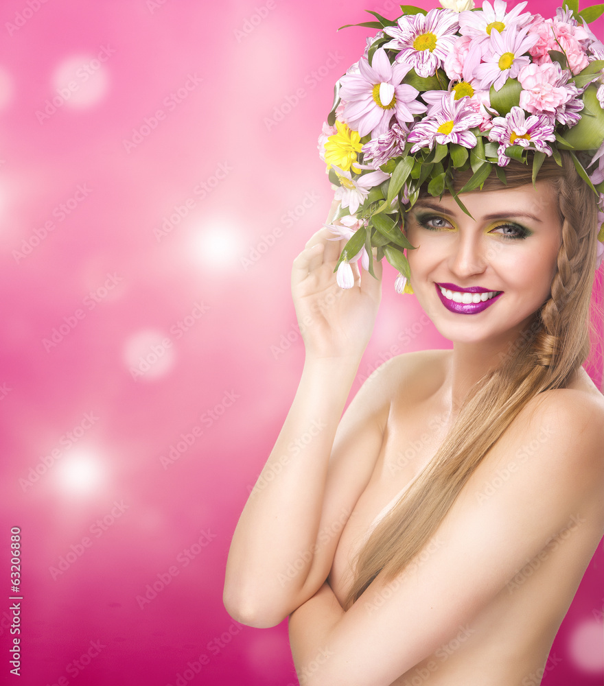 Beautiful smiling woman with spring flowers and big hair