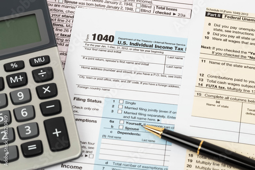 Tax form with pen, and calculator taxation concept