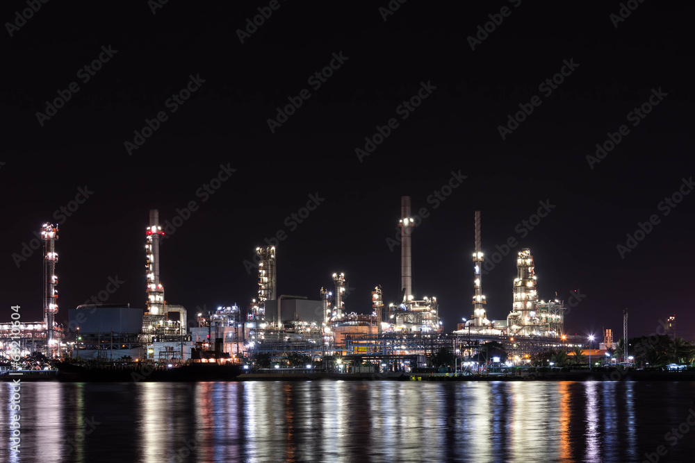 Oil refinery at night with reflection
