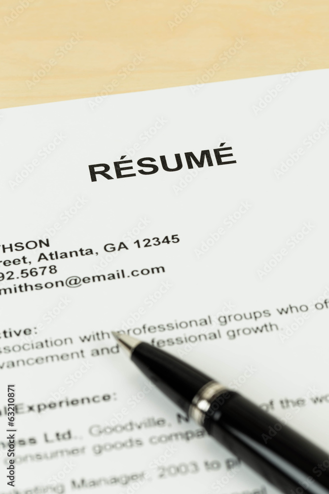 Resume with pen on table closeup Resume with pen on table closeup