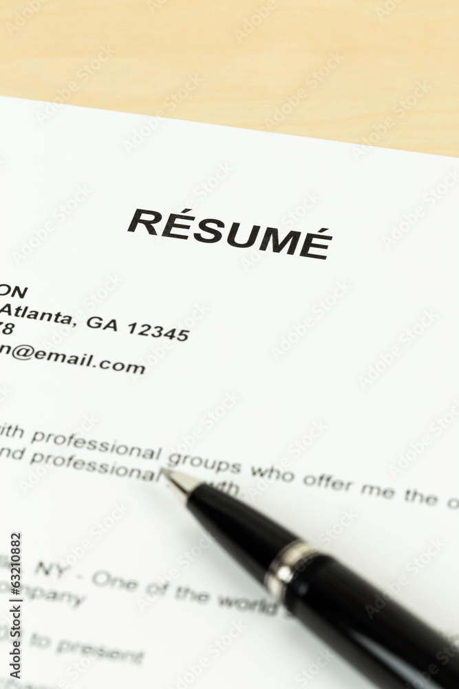Resume with pen on table closeup Resume with pen on table closeup