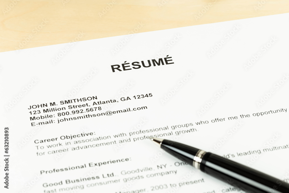 Resume with pen on table closeup Resume with pen on table closeup