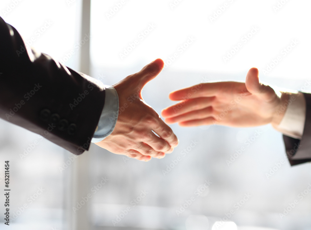 Two business men shaking hands, close up