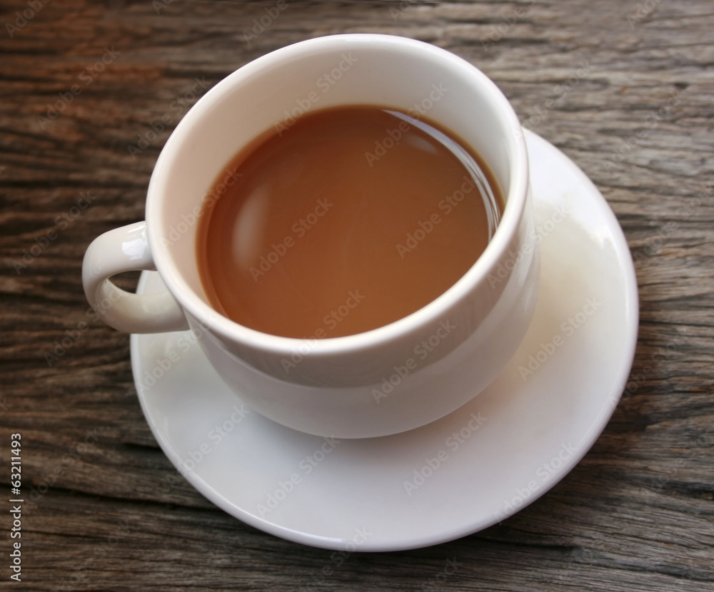 coffee in a white cup on wooden