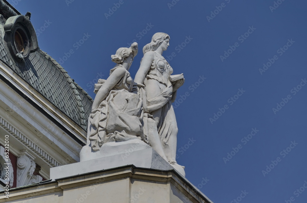 Two woman sculpture on building