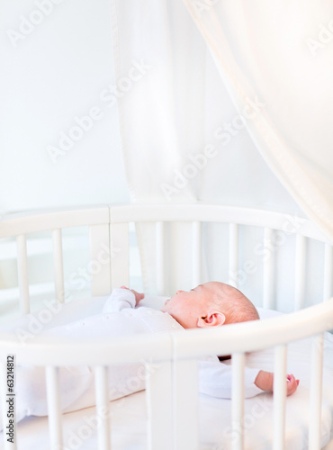 Wallpaper Mural Portrait of a newborn baby boy sleeping in a white round crib Torontodigital.ca