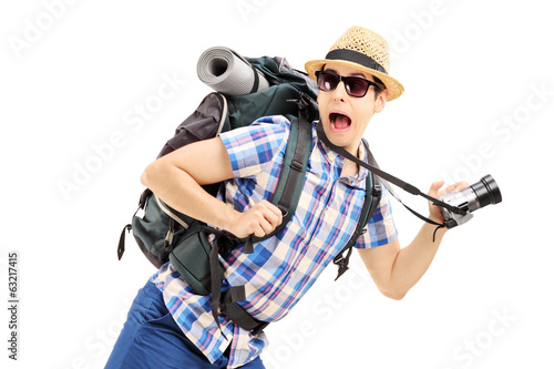 Canvas-taulu Scared hiker with backpack and camera running away
