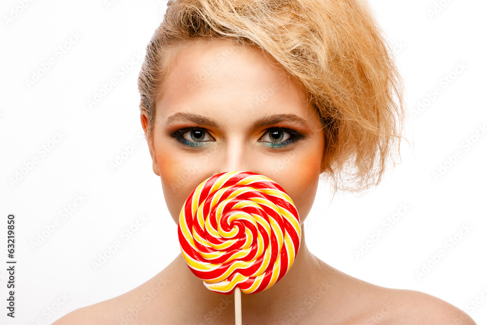 woman licks candy with beautiful make-up