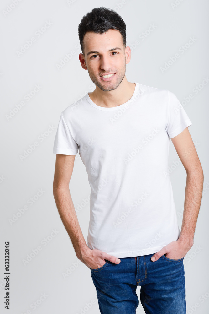 Smiling young man standing against white background Smiling young man standing against white background