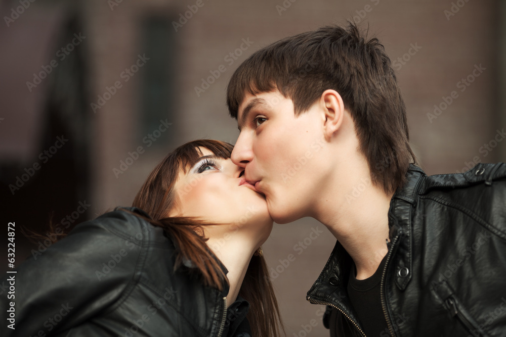 Happy young couple in love kissing outdoor