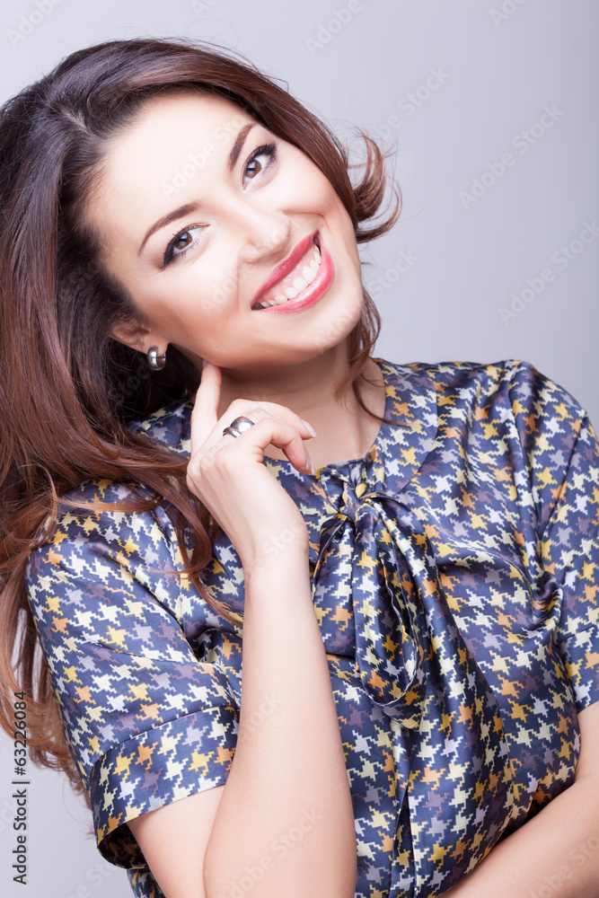 Smiling woman professional make up on grey background Smiling woman professional make up on grey background