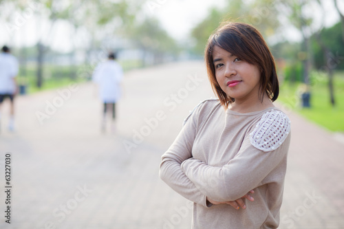 portrait asian woman standing in park. © vachiraphan