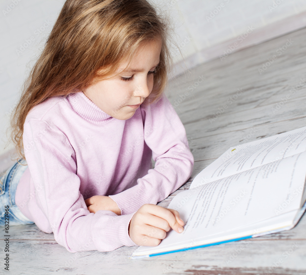 Naklejka premium Child reading book
