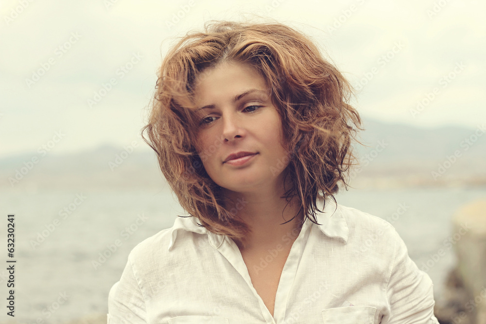 beautiful young woman on a coast sea