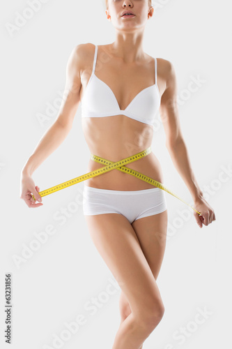 young fitness girl underwear engaged in measurement figures © BestForYou