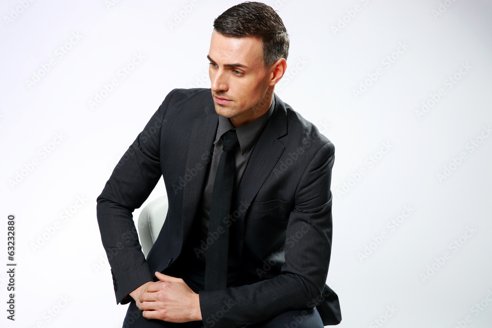 Pensive businessman sitting on the office chair Pensive businessman sitting on the office chair