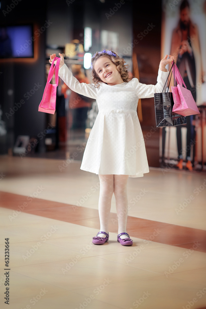 Сute little girl goes to the mall. Сute little girl goes to the mall.