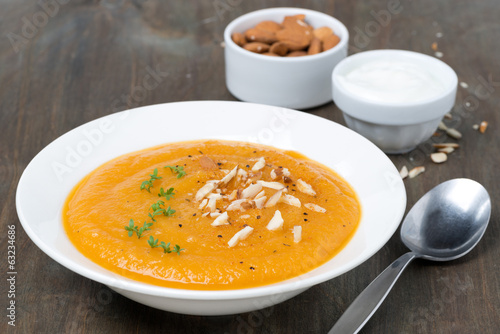 plate of carrot soup with almonds and cress salad