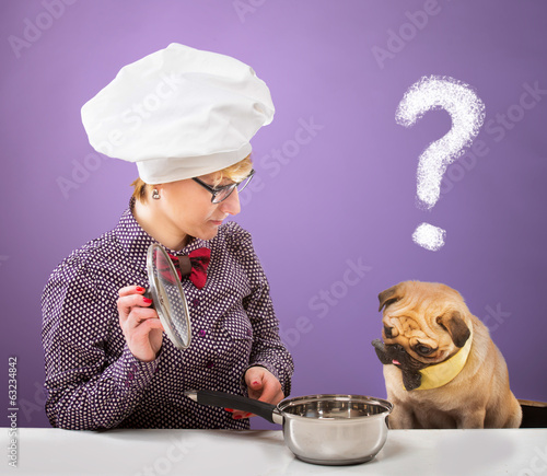 Obraz na plátne Woman and her dog looking at a pot with quizzical expression