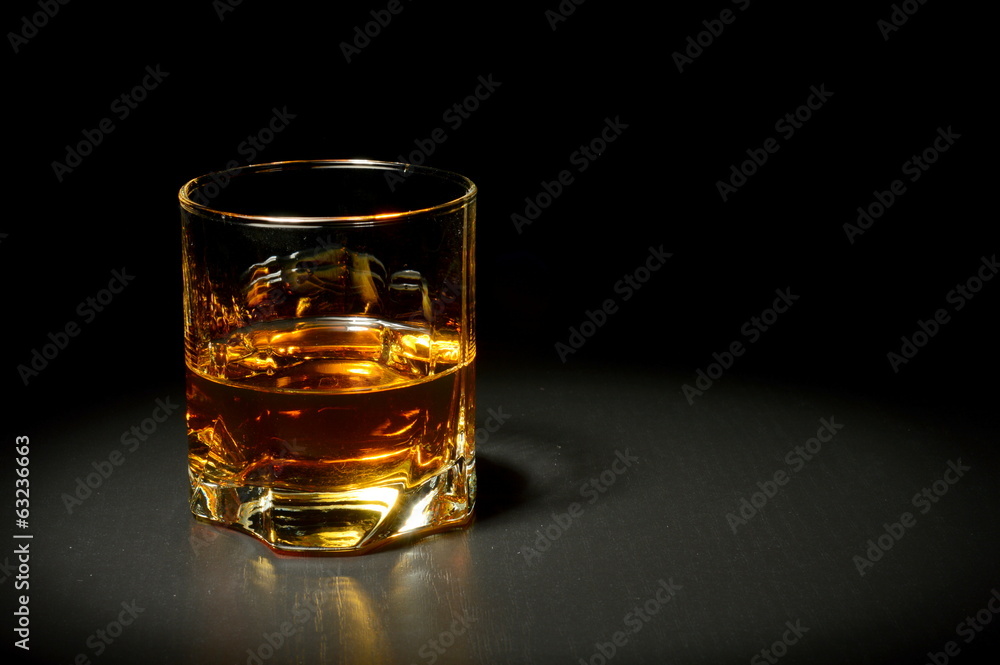 Glass of whiskey on black table Glass of whiskey on black table