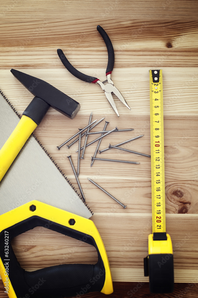 Different tools on a wooden background
