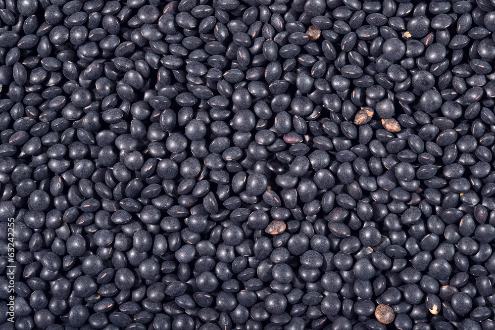 Black raw lentil background Black raw lentil background