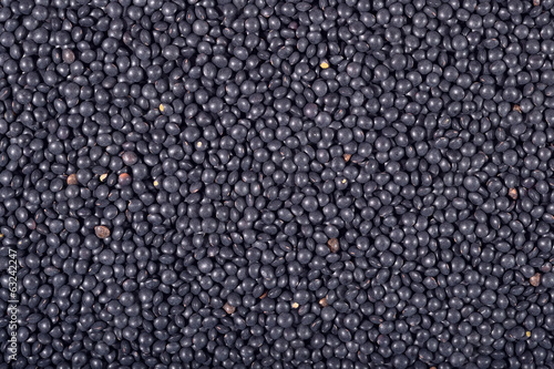 Black raw lentil background