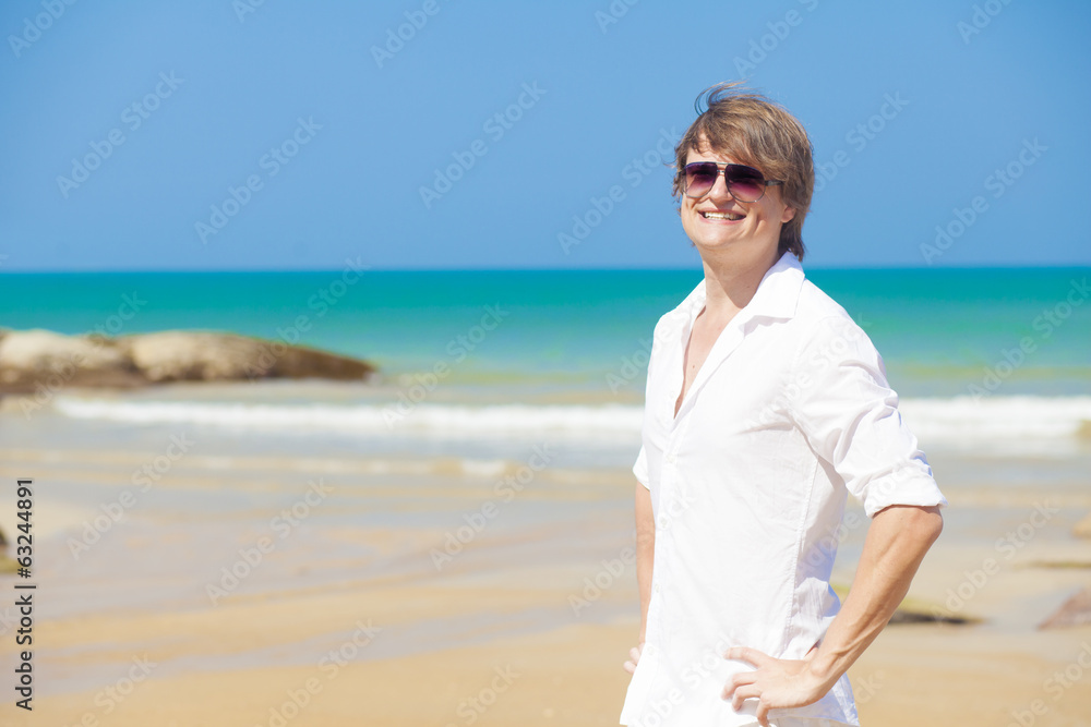 front view young handsome man smiling in white clothes and front view young handsome man smiling in white clothes and