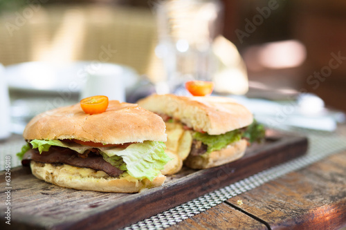 Beef Burger split in half and potatoes with vegetable salad © el.rudakova