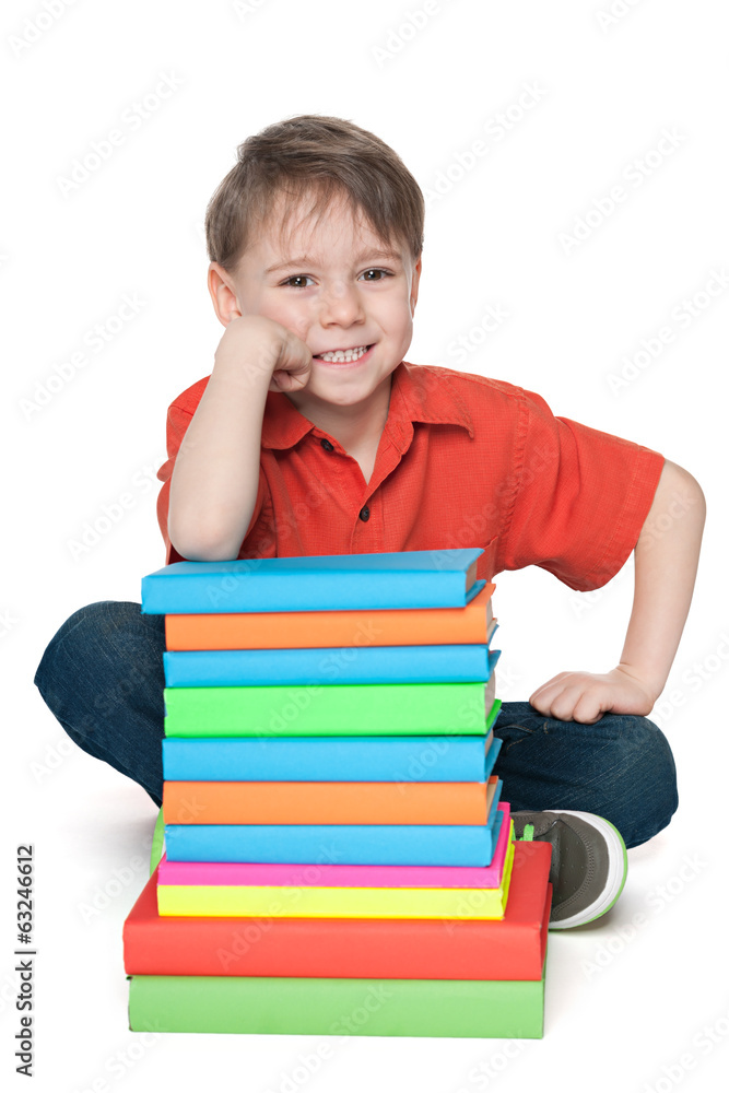 Smiling young boy with books