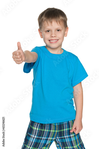 Young boy in blue shirt holds his thumb up