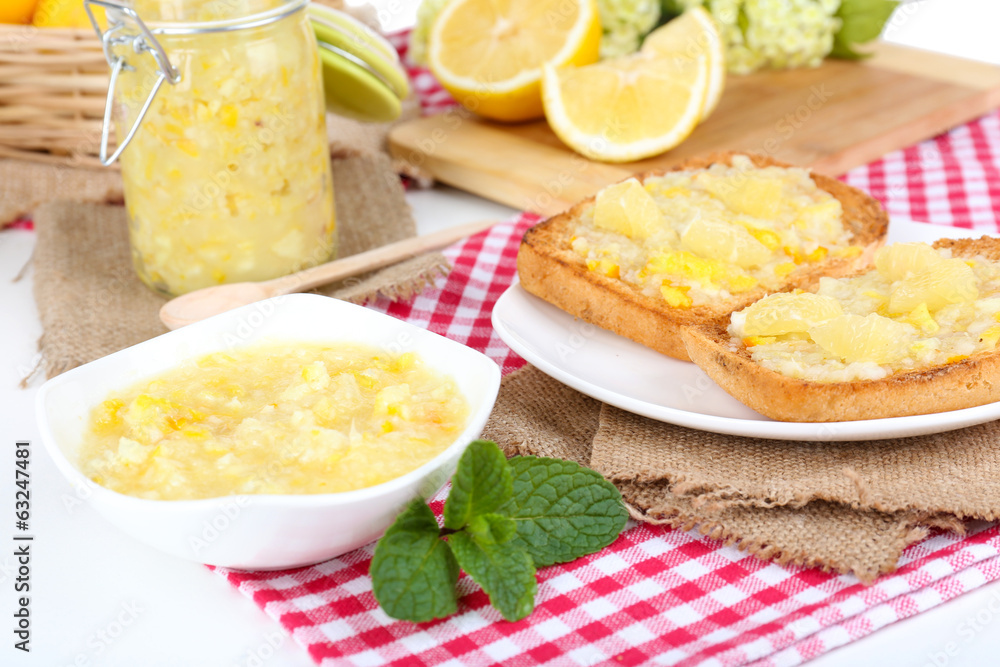 Delicious toasts with lemon jam on plate on table close-up Delicious toasts with lemon jam on plate on table close-up