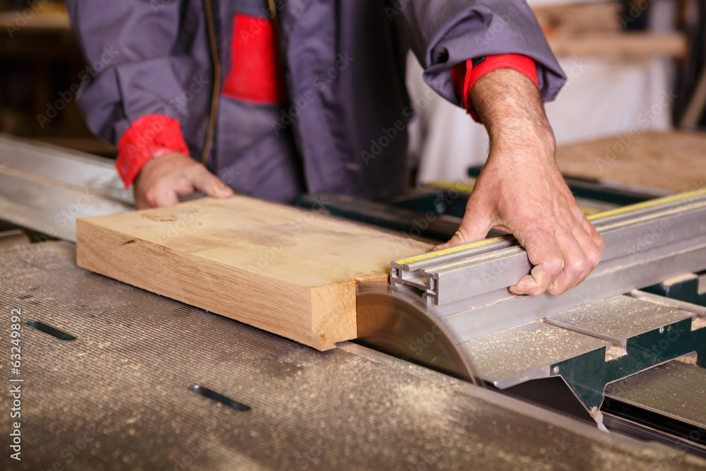 Hands carpenter working with a circular saw Hands carpenter working with a circular saw