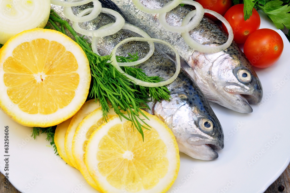 two rainbow trout with lemon and fresh vegetables two rainbow trout with lemon and fresh vegetables