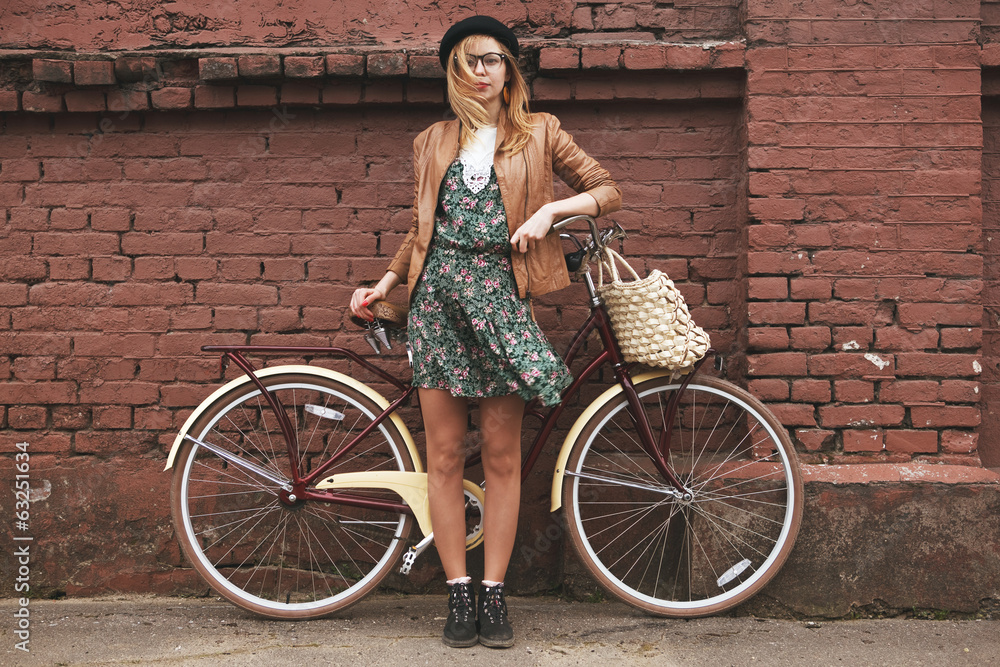 fashionable woman with vintage bike on brick wall background - obrazy, fototapety, plakaty 