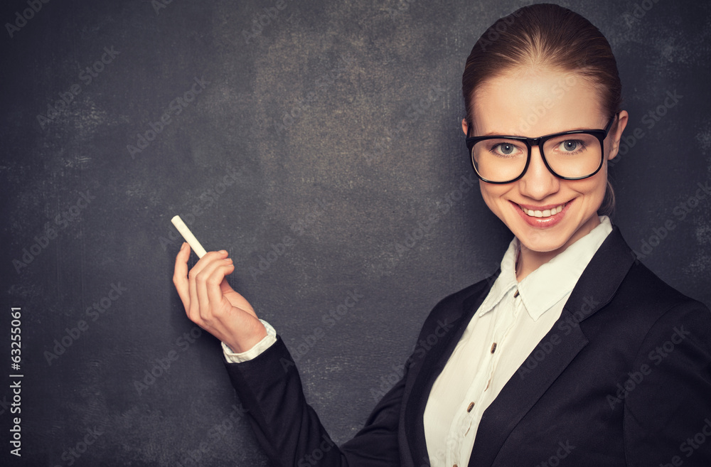 business woman teacher with glasses and a suit with chalk at a business woman teacher with glasses and a suit with chalk at a