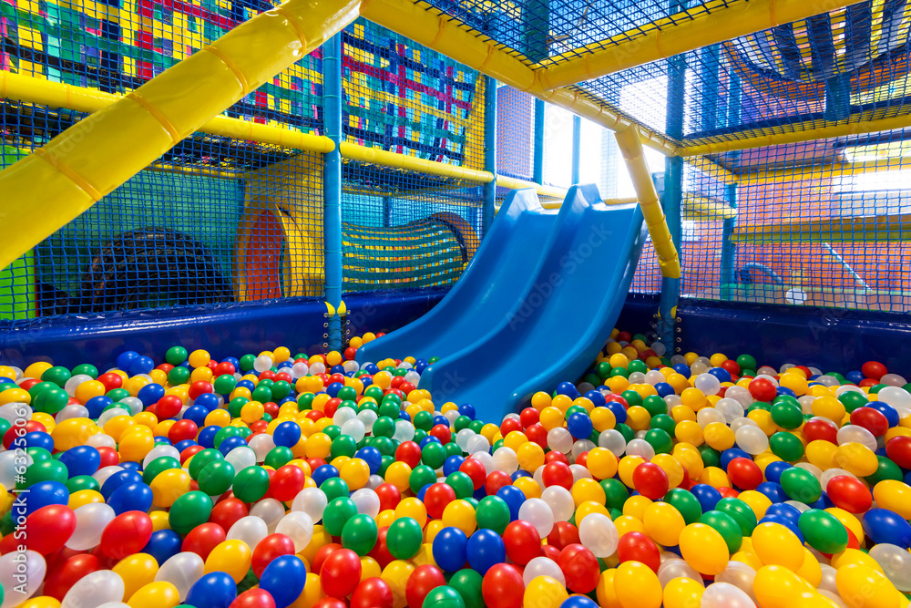 Modern kid's playground with slide and balls indoor - obrazy, fototapety, plakaty 