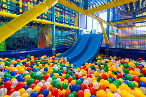 Modern kid's playground with slide and balls indoor